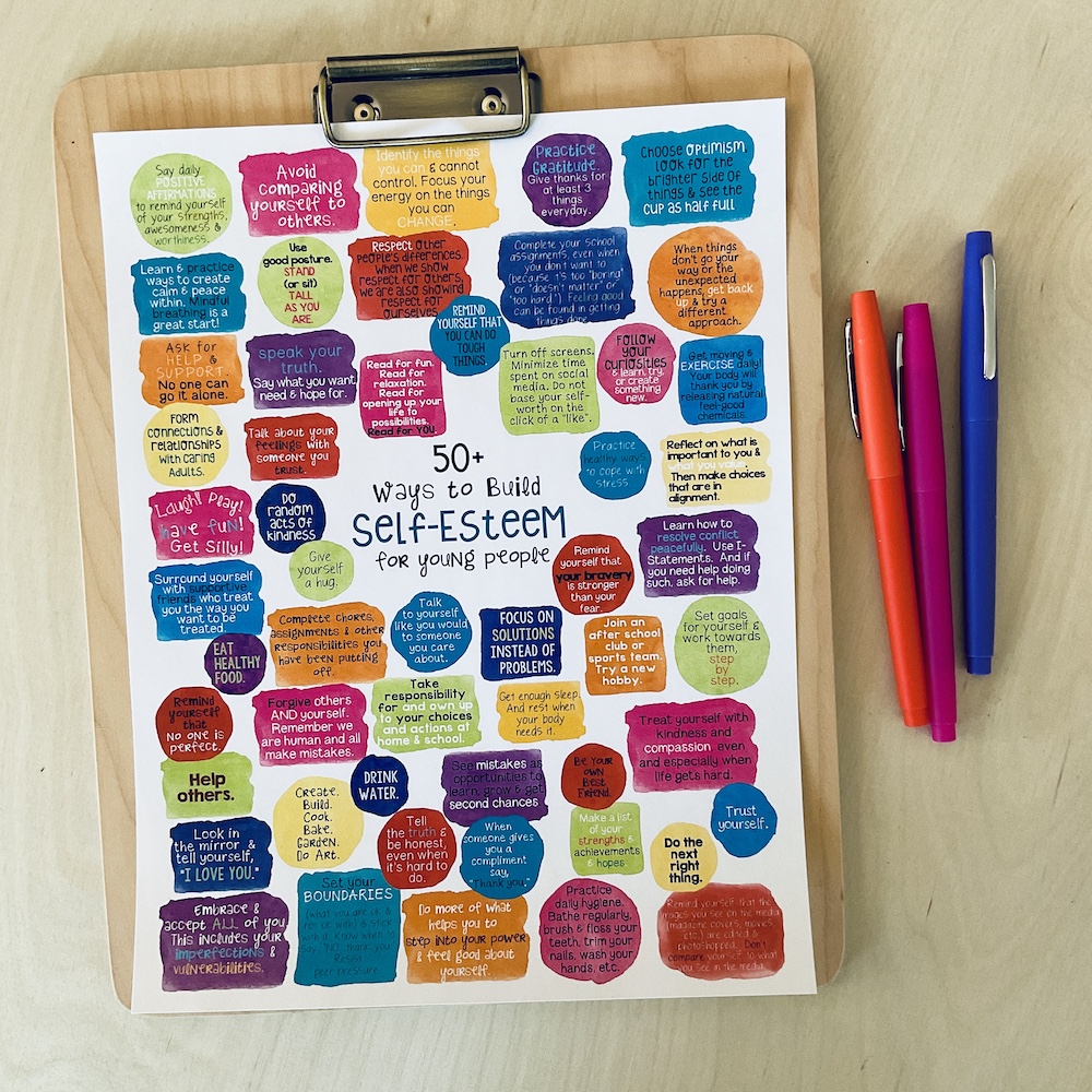 50 ways to help children and teens build self esteem poster on a clipboard next to pens.